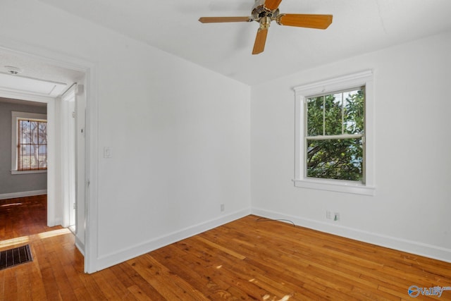 empty room featuring ceiling fan and hardwood / wood-style floors