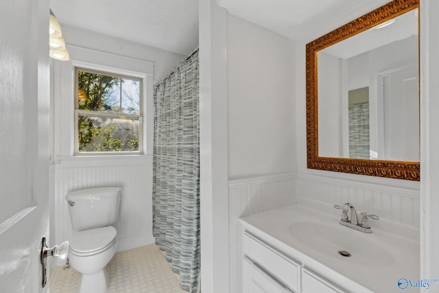 bathroom with toilet, vanity, and a shower with shower curtain