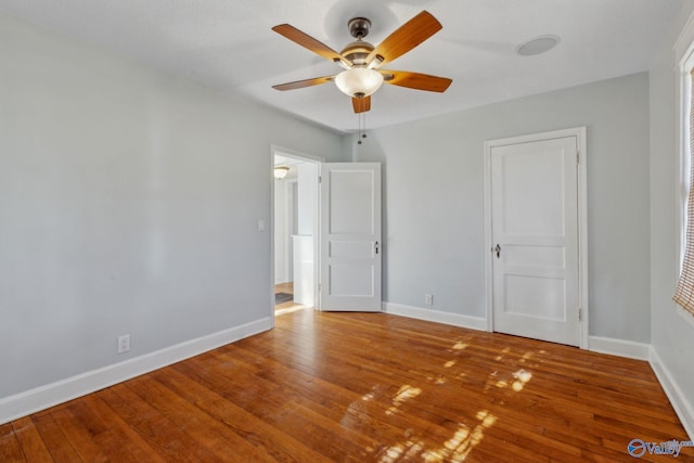 unfurnished bedroom with ceiling fan and hardwood / wood-style floors