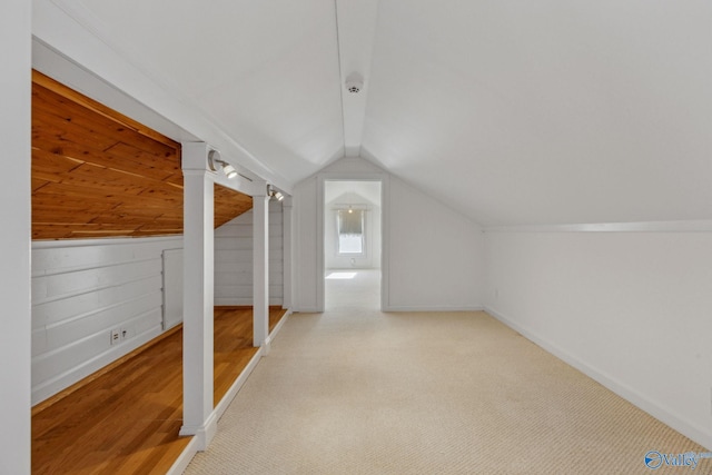 bonus room with lofted ceiling and carpet floors