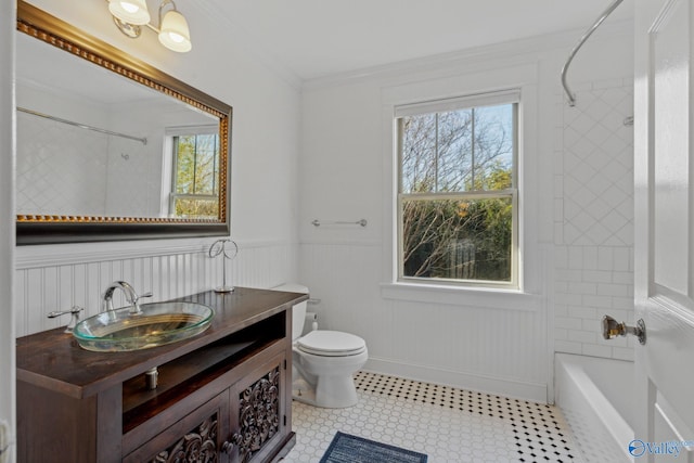 full bathroom with toilet, tiled shower / bath, vanity, and ornamental molding