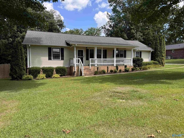 single story home with a porch and a front lawn