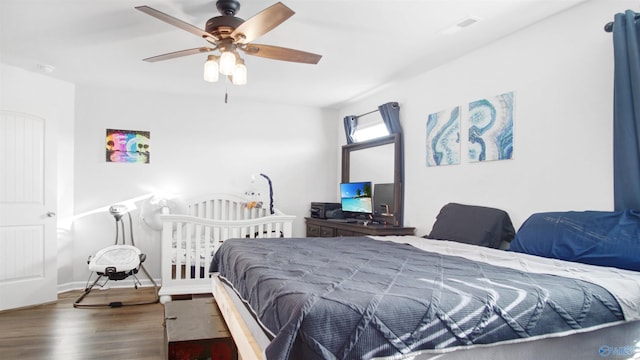 bedroom with baseboards, ceiling fan, and wood finished floors