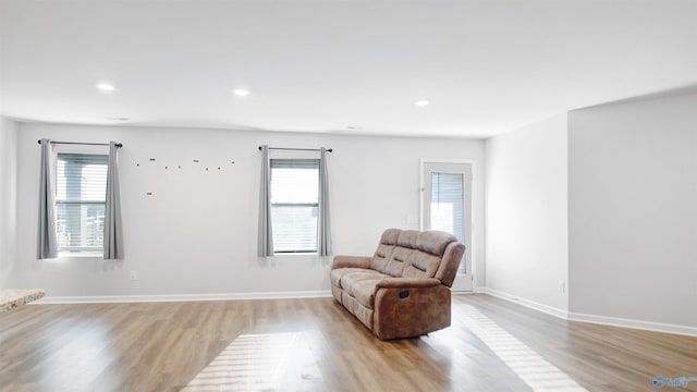 living area with light wood finished floors, baseboards, and recessed lighting