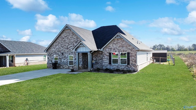 craftsman inspired home with brick siding, a shingled roof, and a front yard