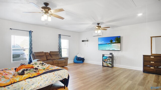 bedroom with baseboards, ceiling fan, light wood-type flooring, and attic access