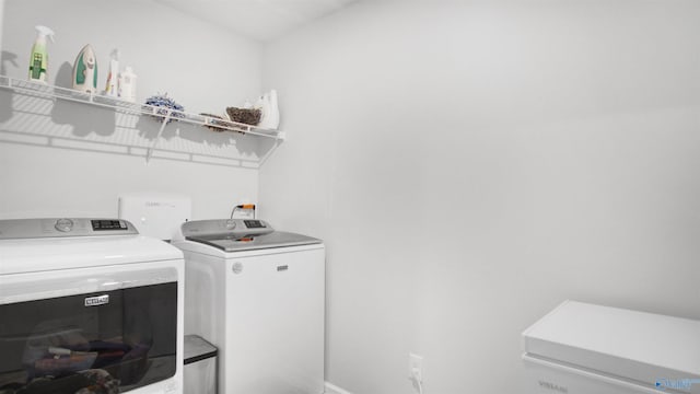 washroom with washing machine and dryer and laundry area