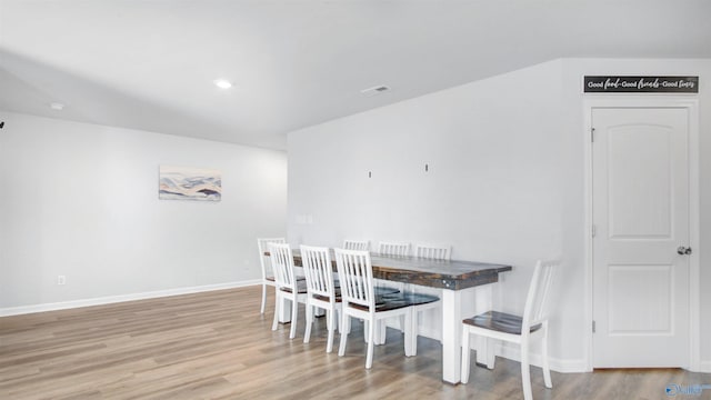 dining room featuring baseboards, visible vents, wood finished floors, and recessed lighting