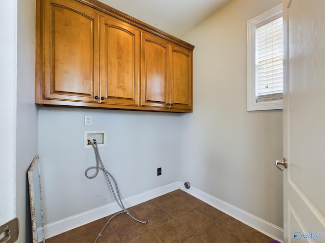 washroom featuring hookup for a washing machine, cabinet space, and baseboards