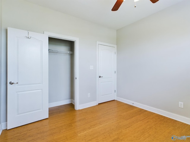 unfurnished bedroom featuring a closet, light wood-type flooring, and baseboards