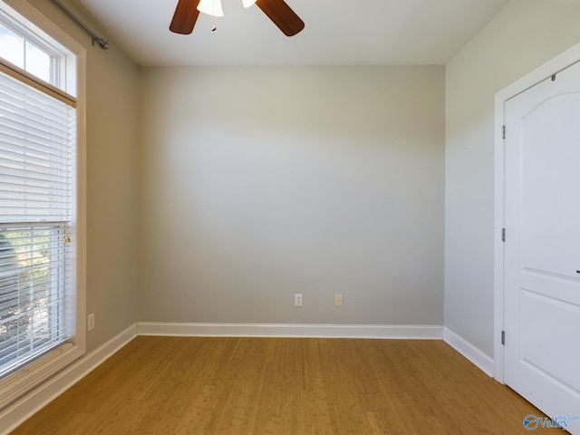 spare room featuring baseboards, plenty of natural light, and light wood-style floors