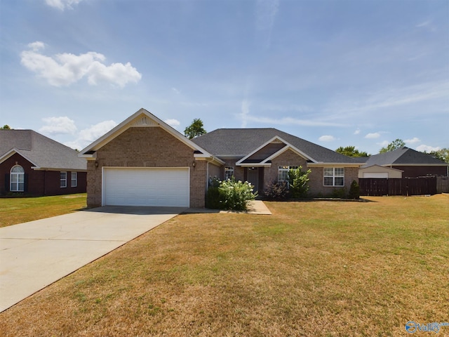 ranch-style home with brick siding, concrete driveway, an attached garage, fence, and a front lawn