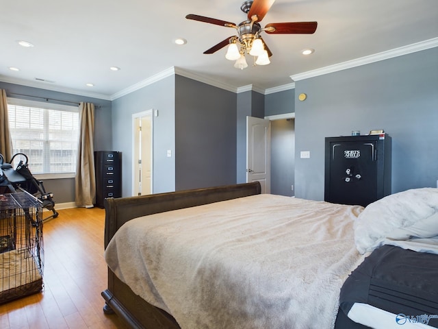 bedroom with ornamental molding, wood finished floors, and recessed lighting