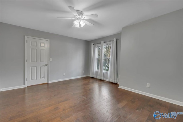 unfurnished room featuring a ceiling fan, wood-type flooring, and baseboards