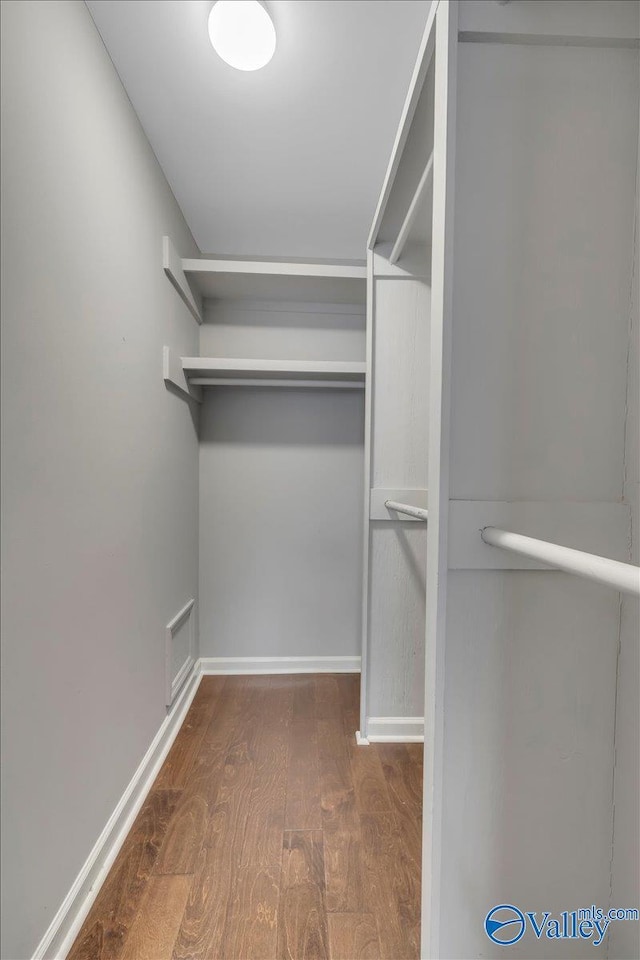 spacious closet with visible vents and wood finished floors