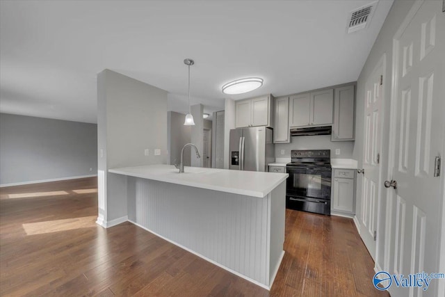 kitchen with stainless steel fridge, visible vents, gray cabinetry, under cabinet range hood, and black range with electric cooktop