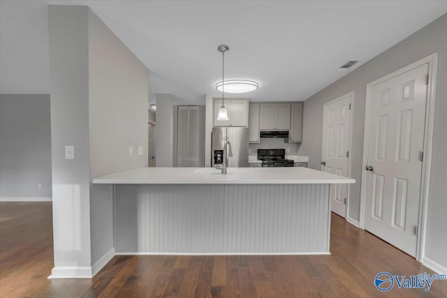 kitchen featuring visible vents, light countertops, gray cabinetry, black range with electric cooktop, and stainless steel refrigerator with ice dispenser