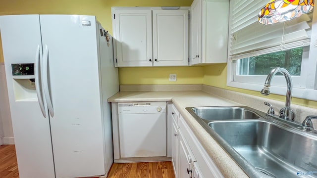 kitchen featuring white appliances, sink, light hardwood / wood-style flooring, and white cabinets