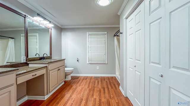 bathroom with crown molding, vanity, toilet, and hardwood / wood-style floors