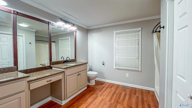 bathroom featuring vanity, hardwood / wood-style floors, crown molding, and toilet