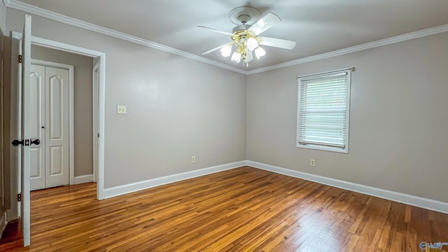 unfurnished room with crown molding, hardwood / wood-style floors, and ceiling fan