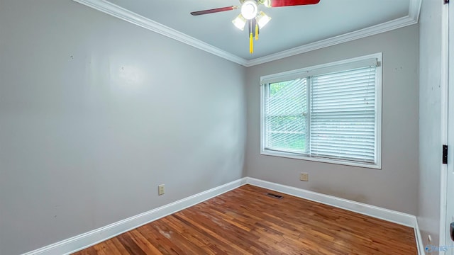 unfurnished room with hardwood / wood-style floors, ornamental molding, and ceiling fan