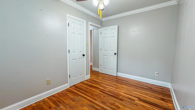 empty room featuring crown molding, ceiling fan, and hardwood / wood-style flooring