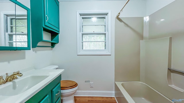 full bathroom with hardwood / wood-style flooring, vanity, toilet, and  shower combination