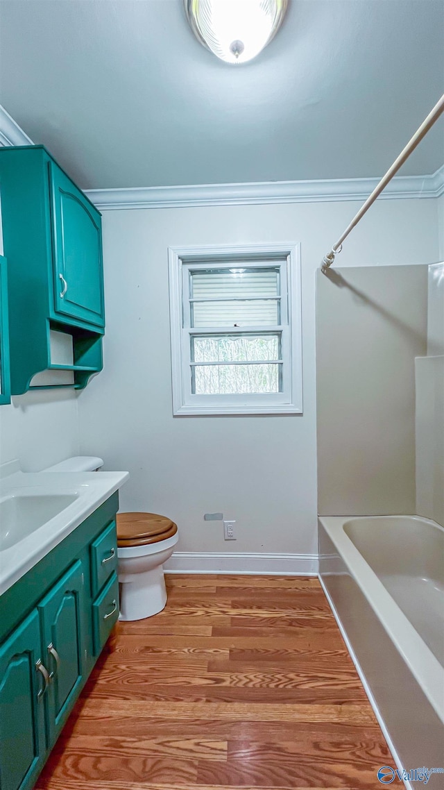 full bathroom featuring crown molding, shower / tub combination, hardwood / wood-style floors, vanity, and toilet