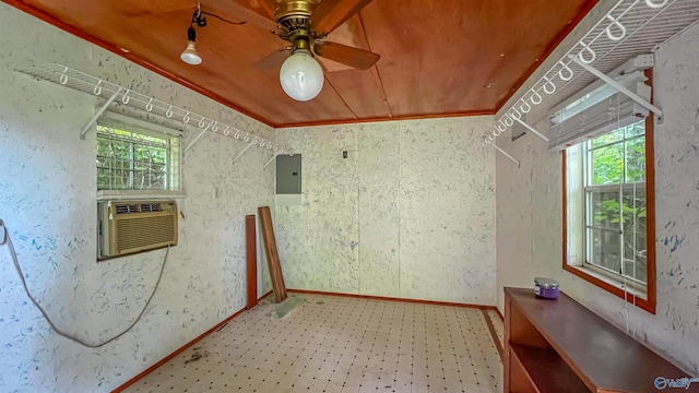 empty room featuring cooling unit, wood ceiling, electric panel, and a healthy amount of sunlight