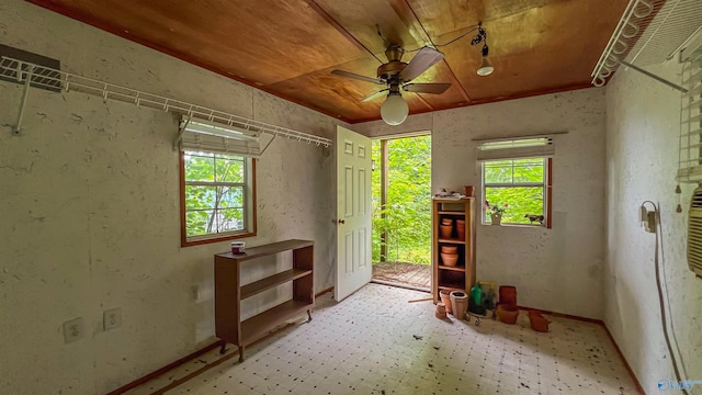 miscellaneous room featuring wood ceiling, ceiling fan, and plenty of natural light