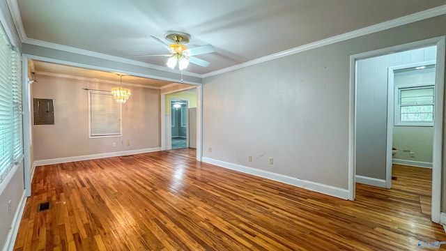 empty room with hardwood / wood-style flooring, crown molding, ceiling fan with notable chandelier, and electric panel