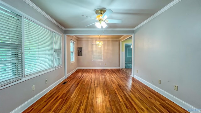 spare room with hardwood / wood-style flooring, crown molding, electric panel, and ceiling fan