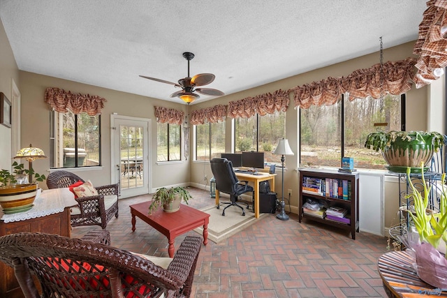 sunroom featuring a ceiling fan