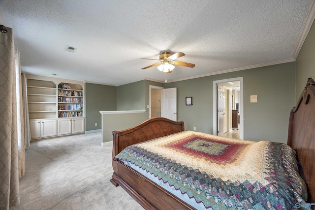 bedroom featuring a textured ceiling, ornamental molding, carpet flooring, and visible vents