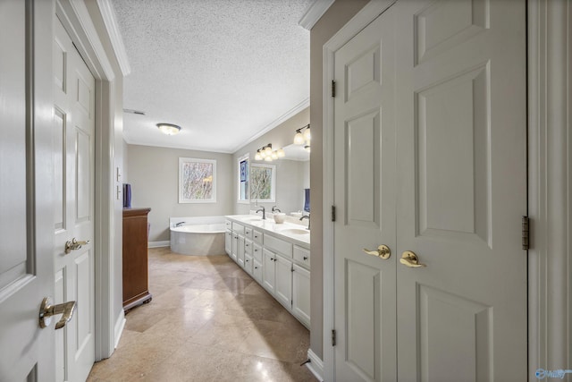 full bathroom with a garden tub, double vanity, ornamental molding, a sink, and a textured ceiling