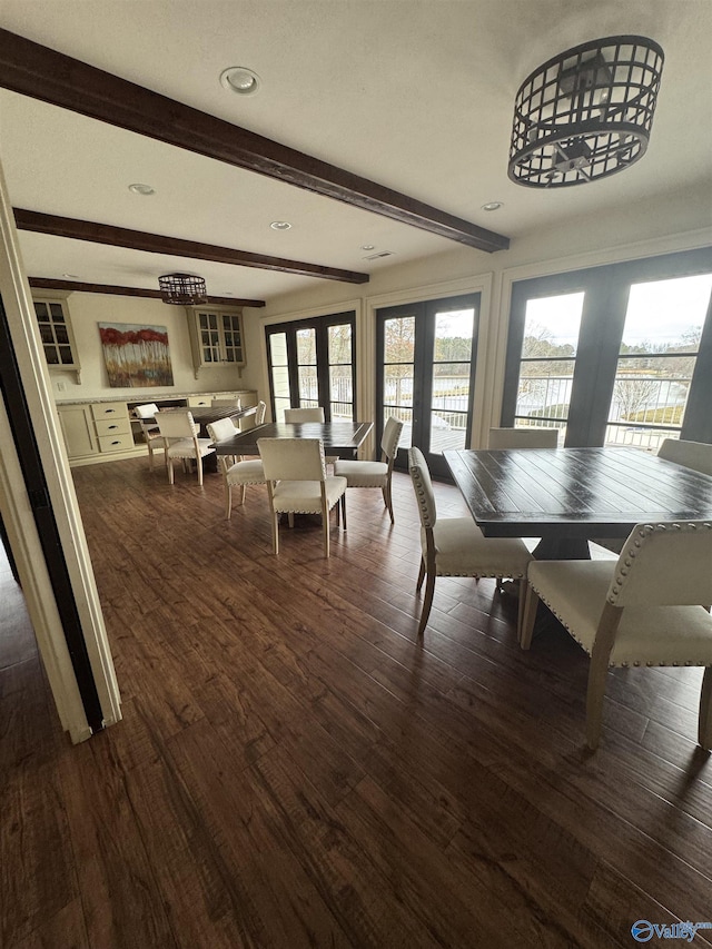 dining room with dark wood-style floors, french doors, and beamed ceiling