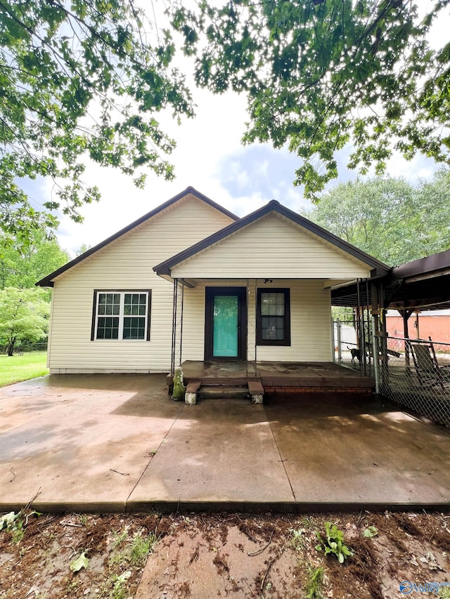 view of front of home featuring covered porch and fence