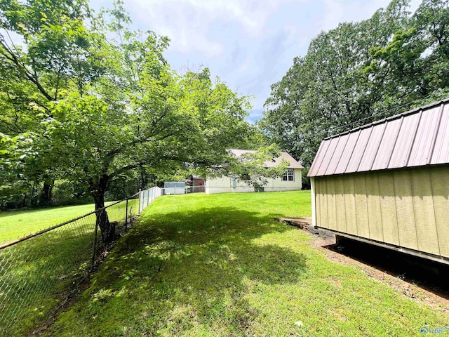 view of yard featuring an outbuilding and a storage shed