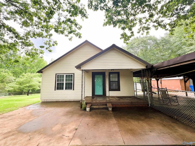 view of front of property featuring covered porch and a carport