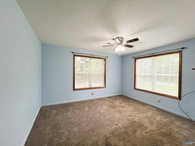 spare room with carpet flooring, baseboards, and ceiling fan