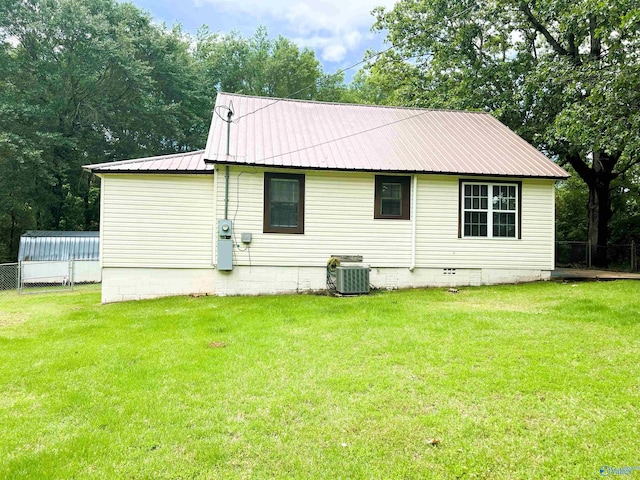back of house featuring central air condition unit and metal roof