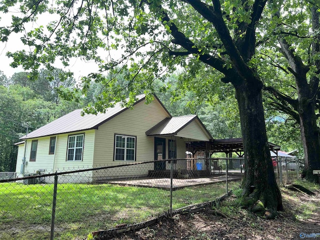 view of front facade featuring metal roof and an attached carport