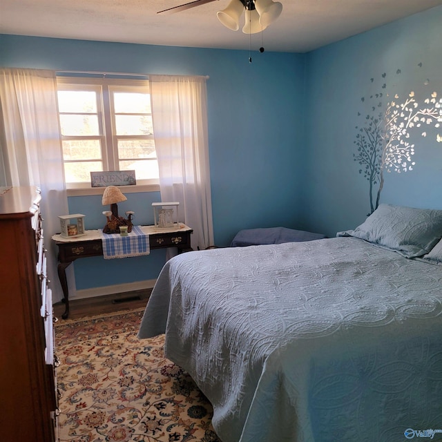 bedroom with ceiling fan and wood-type flooring