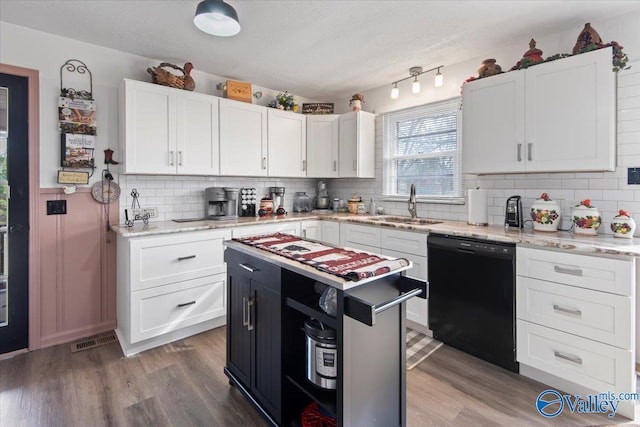 kitchen featuring white cabinetry, a center island, and black dishwasher