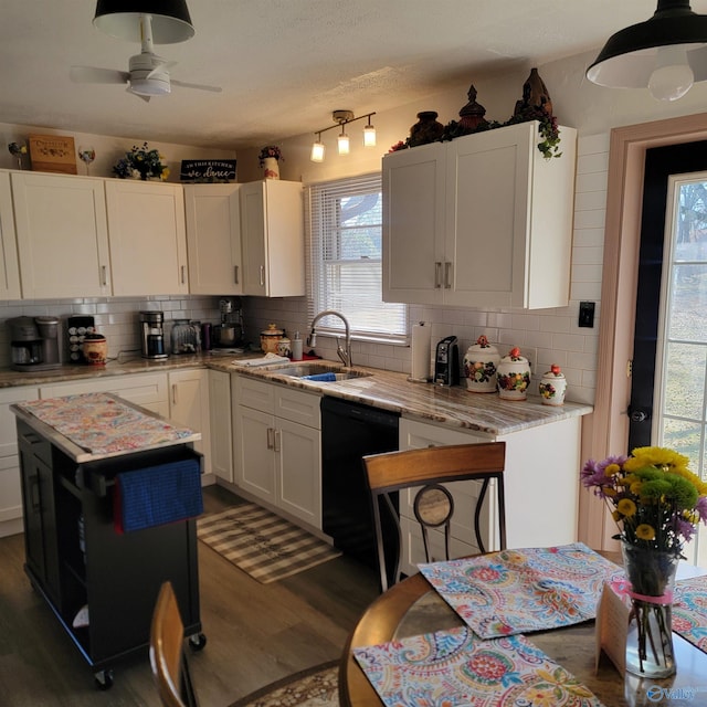 kitchen with dark hardwood / wood-style floors, dishwasher, white cabinetry, sink, and a center island