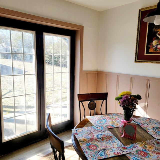 dining space with a healthy amount of sunlight and light hardwood / wood-style floors