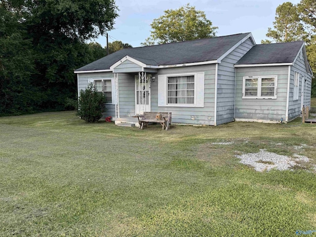5509 Glade Rd, Anniston, AL 36206 - view of front of home with a front lawn and roof with shingles