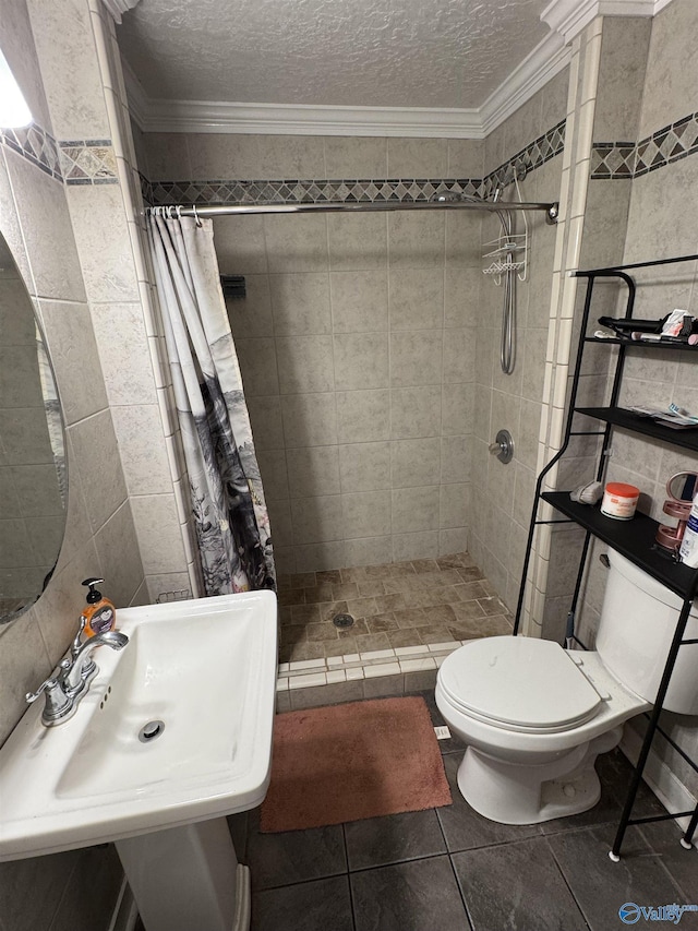 5509 Glade Rd, Anniston, AL 36206 - full bathroom featuring tile walls, crown molding, a shower stall, tile patterned flooring, and a textured ceiling