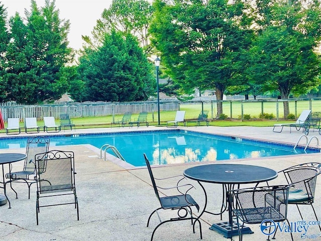 view of swimming pool with a patio